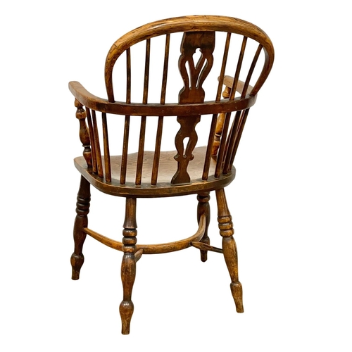 1087 - A mid 19th century Elm Windsor armchair.