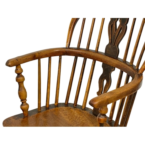 1087 - A mid 19th century Elm Windsor armchair.