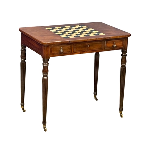 1088 - A George IV mahogany games side table with drawer, on brass cup casters. In the manner of Gillows. C... 