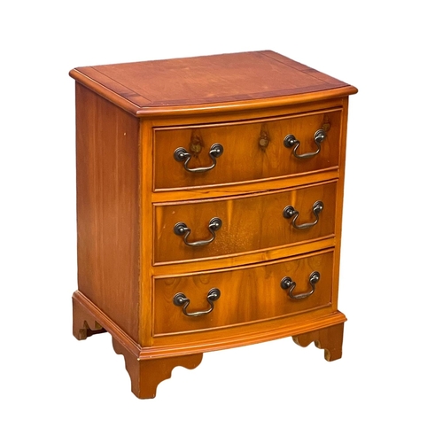 1099 - A small Georgian style inlaid yew wood bow front chest of drawers. 51x49x62cm