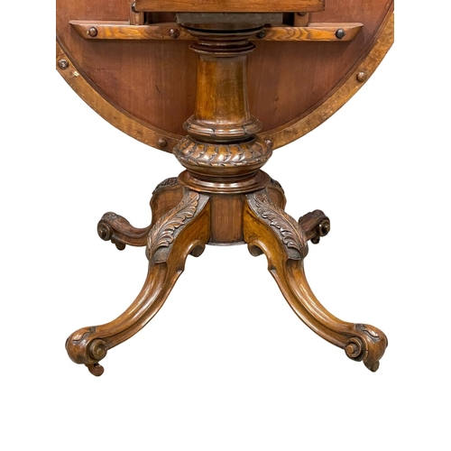 1063 - A Victorian burr walnut tilt top breakfast table.  128x98x75cm