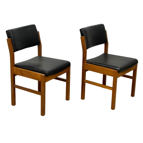 1074 - A pair of good quality Mid Century teak desk chairs with black vinyl seats and backs