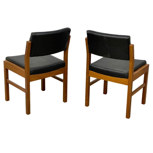 1074 - A pair of good quality Mid Century teak desk chairs with black vinyl seats and backs