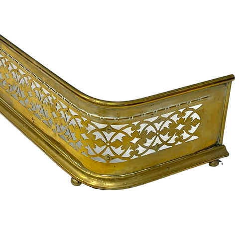 780 - A late Georgian pierced brass fender.  139x31cm