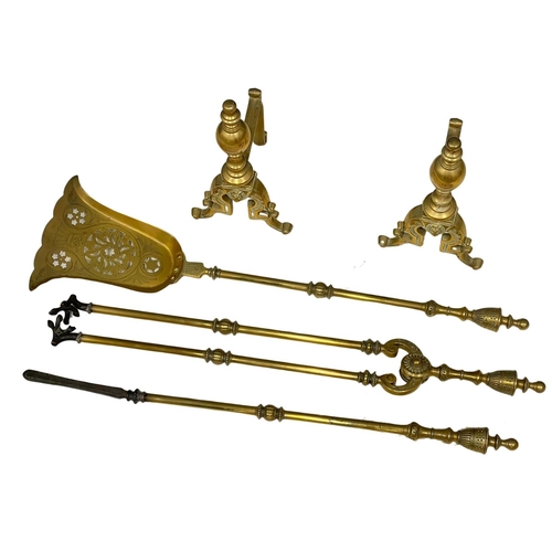 781 - A set of early 20th century brass fire andirons and tools.