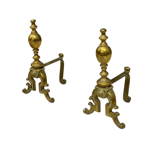 781 - A set of early 20th century brass fire andirons and tools.