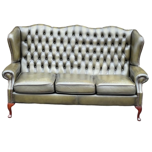 1102 - A deep button leather wingback 3 seater sofa. 180cm