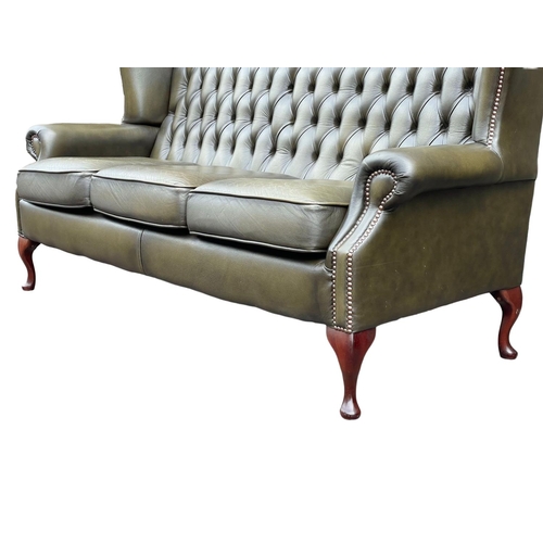 1102 - A deep button leather wingback 3 seater sofa. 180cm