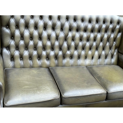 1102 - A deep button leather wingback 3 seater sofa. 180cm