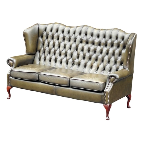 1102 - A deep button leather wingback 3 seater sofa. 180cm