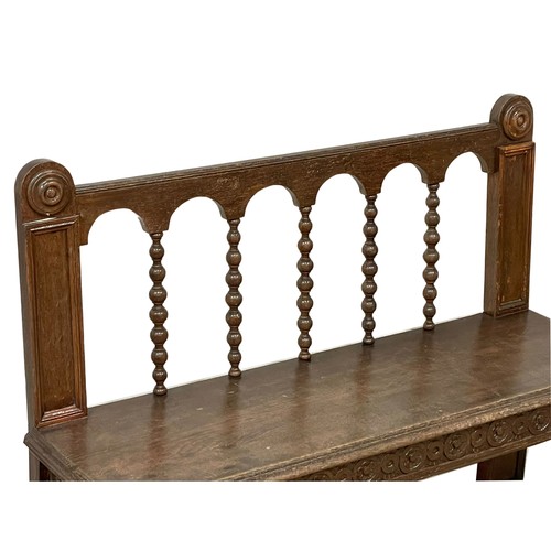 1033 - A Victorian carved oak hall bench on lion paw feet. Circa 1860. 123x40x94cm