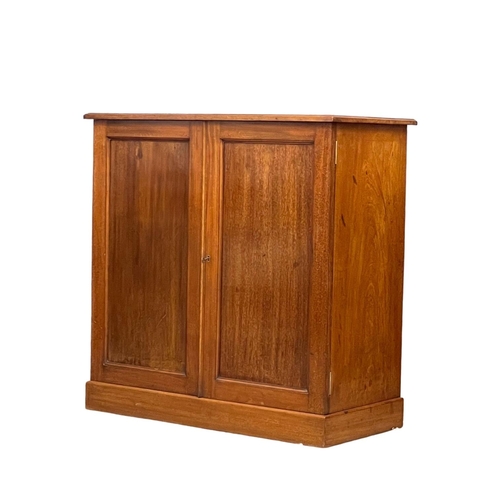 869A - A Heal & Son mahogany 2 door side cabinet with adjustable shelves. Circa 1900. 84x41x83cm