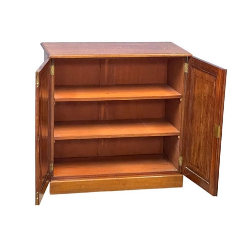 869A - A Heal & Son mahogany 2 door side cabinet with adjustable shelves. Circa 1900. 84x41x83cm