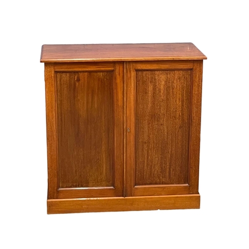 869A - A Heal & Son mahogany 2 door side cabinet with adjustable shelves. Circa 1900. 84x41x83cm