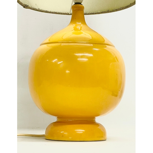 4 - A large Mid Century mustard glazed pottery table lamp. Base measures 23x35cm without shade.