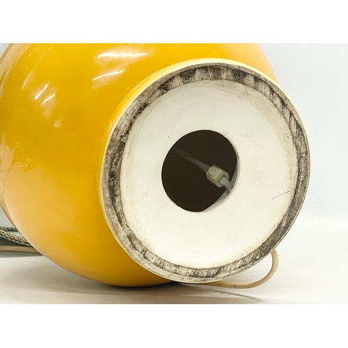 4 - A large Mid Century mustard glazed pottery table lamp. Base measures 23x35cm without shade.