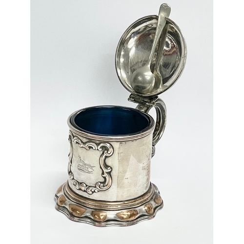 14 - A 19th century ornate silver plated mustard pot with original Bristol Blue liner. 10x8x7cm