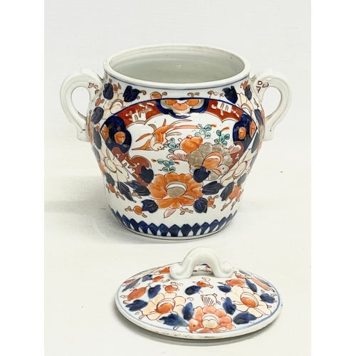 42 - An early 19th century English Imari pattern pottery 2 handled jar with lid. 17.5x16cm