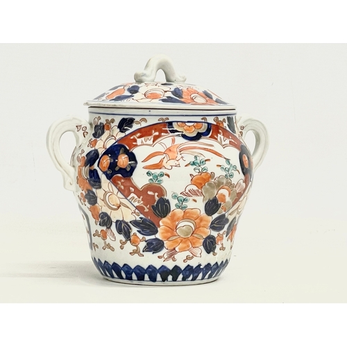 42 - An early 19th century English Imari pattern pottery 2 handled jar with lid. 17.5x16cm