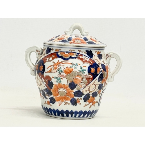 42 - An early 19th century English Imari pattern pottery 2 handled jar with lid. 17.5x16cm