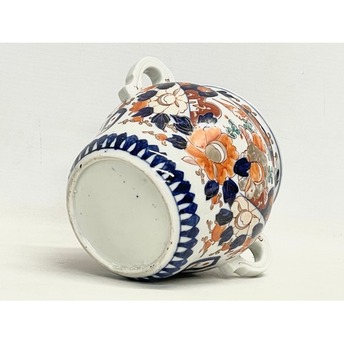 42 - An early 19th century English Imari pattern pottery 2 handled jar with lid. 17.5x16cm