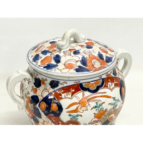 42 - An early 19th century English Imari pattern pottery 2 handled jar with lid. 17.5x16cm