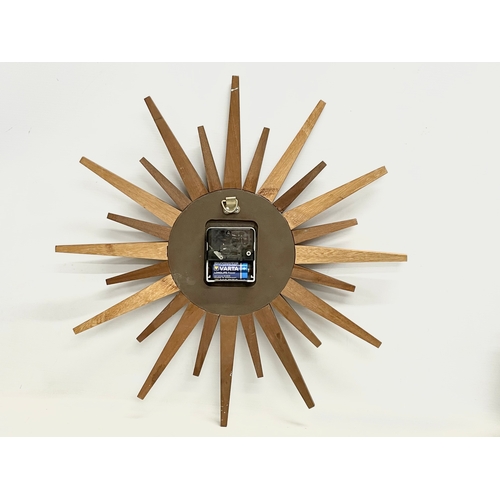 18 - A Mid Century teak ‘Sunburst’ wall clock by Eurastyle. 48cm