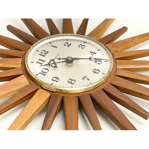 18 - A Mid Century teak ‘Sunburst’ wall clock by Eurastyle. 48cm