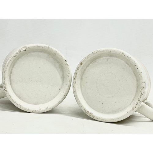 73 - A pair of Victorian glazed mugs. 14x10cm