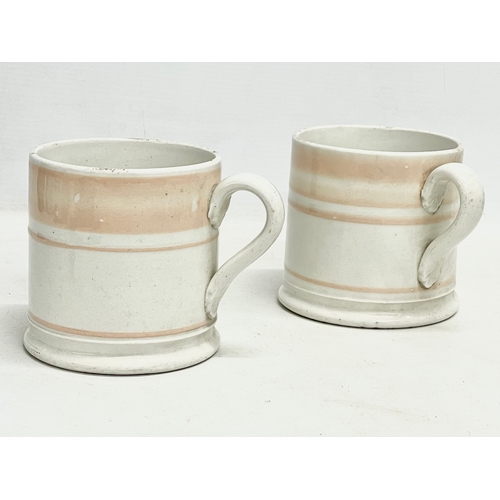 73 - A pair of Victorian glazed mugs. 14x10cm