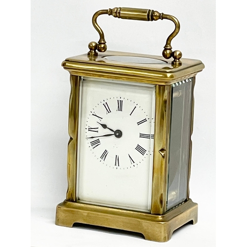 19 - An early 20th century French brass carriage clock. Circa 1900. 8x6x15cm including handle.