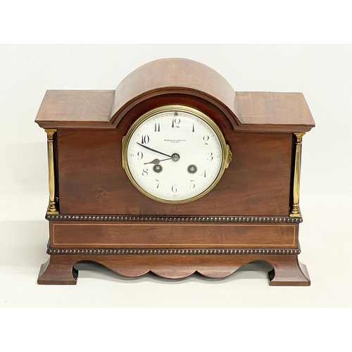 46 - A late Edwardian inlaid mahogany mantle clock with brass mounts, key and pendulum. Riddles Limited, ... 