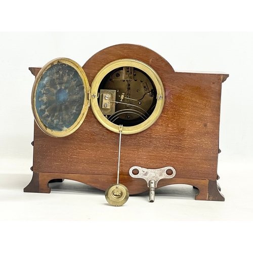 46 - A late Edwardian inlaid mahogany mantle clock with brass mounts, key and pendulum. Riddles Limited, ... 