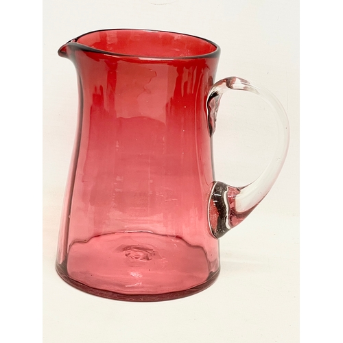 58 - A collection of Victorian Cranberry and Ruby Glass. Largest Ruby Glass jug measures 18x18cm. A pair ... 