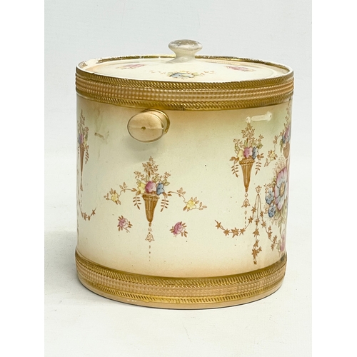 106 - A 1920’s Devon Ware Fieldings ‘Spring’ pattern pottery biscuit barrel. 17x14x15cm