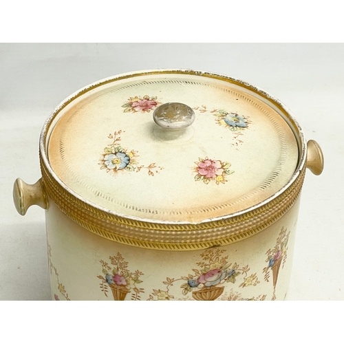 106 - A 1920’s Devon Ware Fieldings ‘Spring’ pattern pottery biscuit barrel. 17x14x15cm