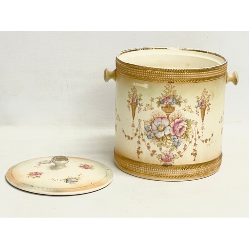 106 - A 1920’s Devon Ware Fieldings ‘Spring’ pattern pottery biscuit barrel. 17x14x15cm