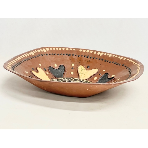 88 - A large late 19th century continental Slipware terracotta bowl. 43x43x9cm