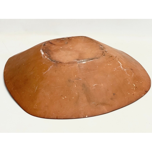 88 - A large late 19th century continental Slipware terracotta bowl. 43x43x9cm