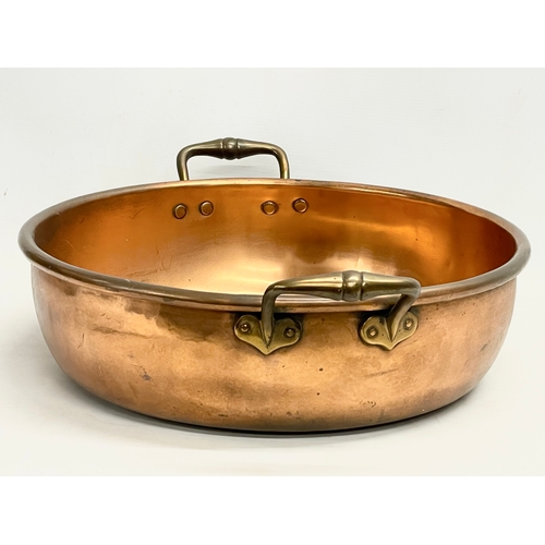 62 - A large Victorian copper 2 handled jam pan. 55x44x16cm