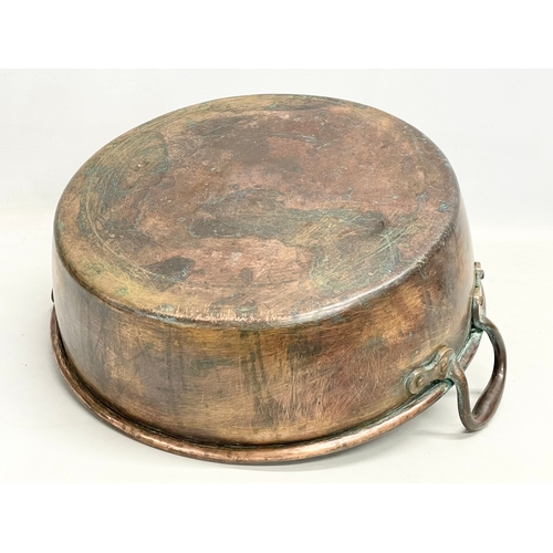 63 - A large Victorian copper 2 handled jam pan. 47x40x19cm