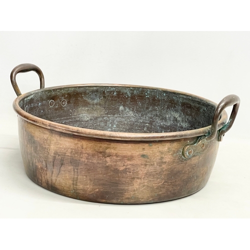 63 - A large Victorian copper 2 handled jam pan. 47x40x19cm