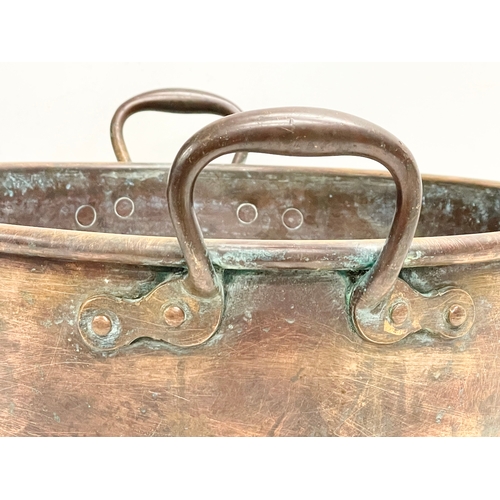 63 - A large Victorian copper 2 handled jam pan. 47x40x19cm