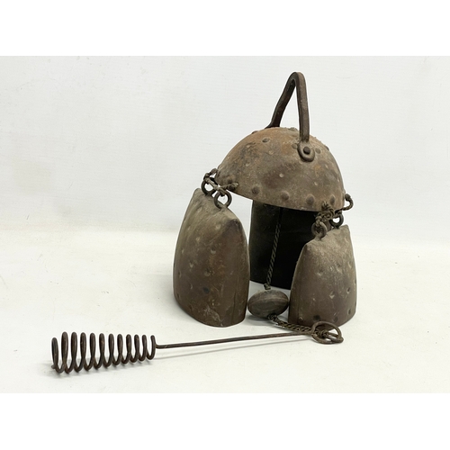 59 - A 19th century cow bell wind chime. 55cm