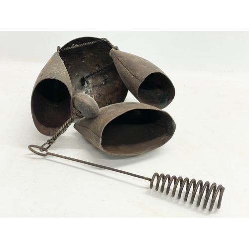 59 - A 19th century cow bell wind chime. 55cm