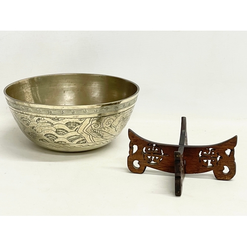 60 - A large early 20th century Chinese brass bowl on wooden stand. Bowl measures 24x11cm.