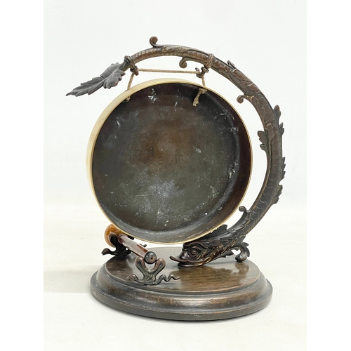 91 - A late 19th century brass gong on spelter and wooden frame. 20x24cm