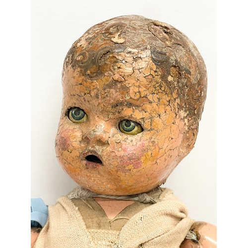 93 - An early 20th century doll. 35cm