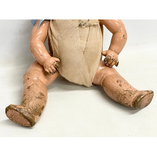 93 - An early 20th century doll. 35cm