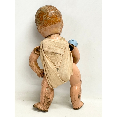 93 - An early 20th century doll. 35cm